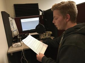 Lucas Metzner voices over his teams story on paying for college at the TMJ4 studio.