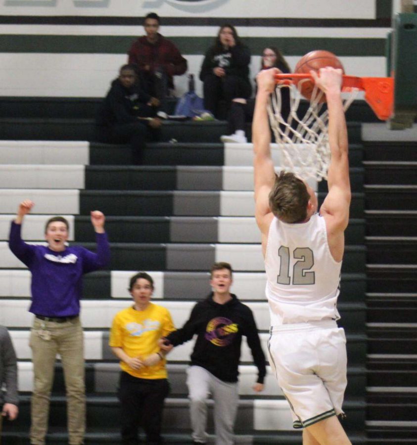 Senior Guard Dylan Parker dunks the basketball at a home game earlier this season.
