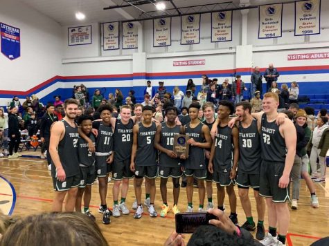 The Wauwatosa West Boys Basketball team with their regional championship trophy after defeating Wisconsin Lutheran 69-49.