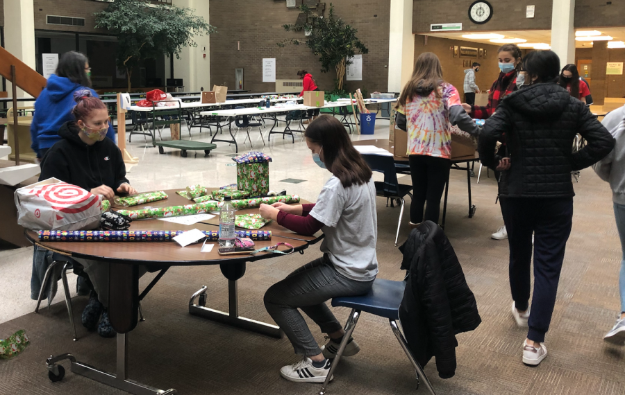 Key Club members wrap gifts in the learning center during the holiday season. The gifts went to families and children in need. 