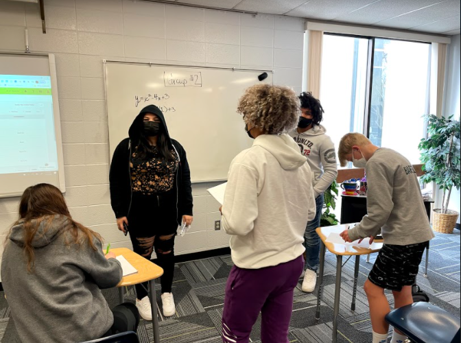 Students+from+Wauwatosa+Wests+AVID+class+put+their+heads+together+to+solve+a+math+problem+during+their+second+hour+class.+AVID+has+been+running+trial+classes+at+the+highschools+for+two+years.+The+district+has+recently+decided+to+expand+the+program+and+get+more+students+involved.