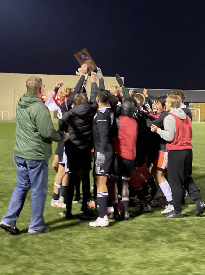 The Wauwatosa West Varsity Boys Soccer team celebrates with their regional plaque before taking on Whitefish Bay in their first sectional game. 