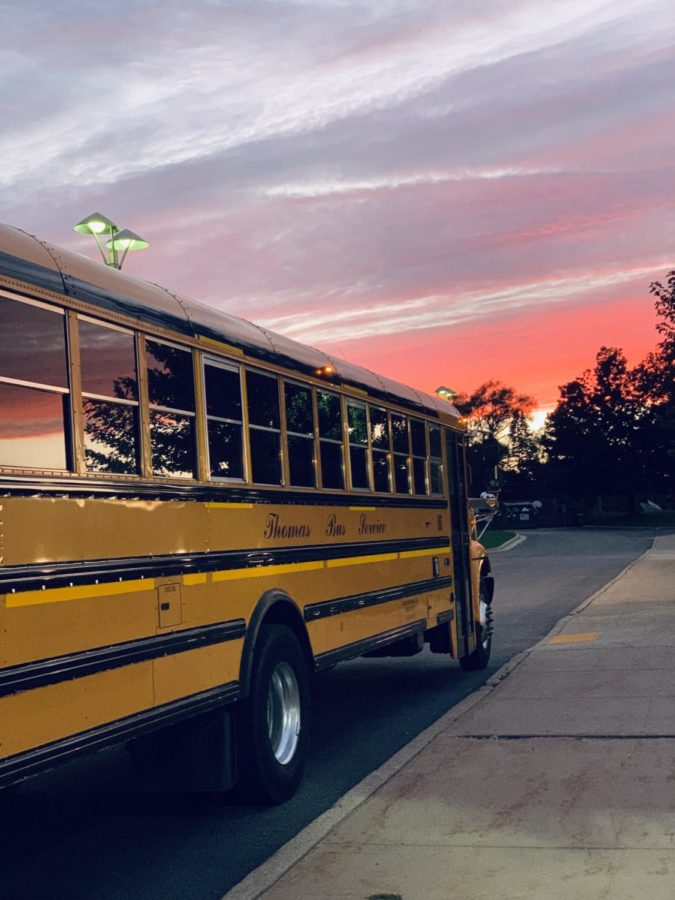 A bus sits outside Wauwatosa West during the evening, waiting for students after their activities. Buses across the nation have been very difficult to secure for school events.