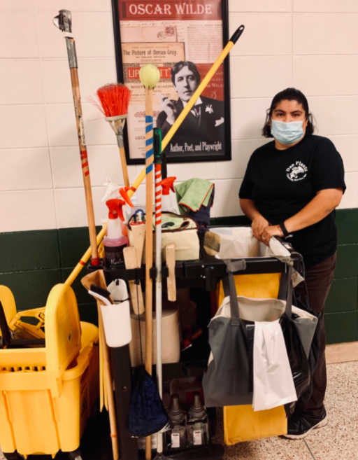 Custodian, Ana Rangel, stands by her cleaning cart during the school day. 