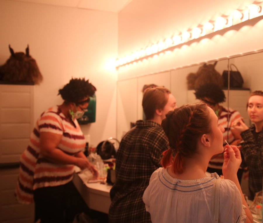 Actors putting on makeup. 