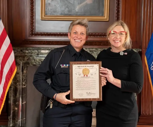 Officer Tracy Burbach is recognized by Representative Robyn Vining. 